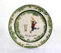 ‘Out for a Duck’. A Royal Doulton Black Boy plate, entitled ‘Out for a Duck’ printed with a boy in red shirt and a floppy hat swinging the bat and being bowled out, the wicket broken. Green floral decoration to outer rim. 8.5” diameter. Doulton backstamp 