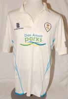 Derbyshire C.C.C. A match worn Derbyshire 1st XI white short sleeve shirt with blue trim, County emblem to chest and sponsor’s logos to front and reverse. Player’s name and number ‘Groenewald 12’ (Tim Groenewald, Derbyshire 2009-2014)) to reverse. Sold wi