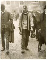 Eton Wall Game c.1920s. Two original mono press photographs, one depicting an Etonian full length in attire including striped woollen scarf and carrying a matching hat, surrounded by smartly dressed onlookers wearing suits and headgear of the period. Penc