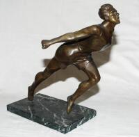 Athletics. ‘Breaking the Tape’. Bronze figure of an athlete lunging forward to complete a race. The elegant figure on marble base measures 13.5” tall. Maker and date unknown, possibly 1930s. Repair to top of left leg, otherwise a nice piece in good condit