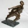 Athletics. ‘Breaking the Tape’. Bronze figure of an athlete lunging forward to complete a race. The elegant figure on marble base measures 13.5” tall. Maker and date unknown, possibly 1930s. Repair to top of left leg, otherwise a nice piece in good condit