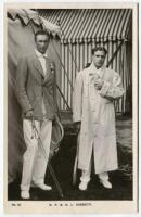 R.F. & H.L. Doherty. Rare original and early mono real photograph postcard of the brothers, Reginald ‘Reggie’ and Laurence ‘Laurie’ Doherty, standing full length holding rackets and wearing tennis attire, Reginald with a blazer, Laurie in a full length wh