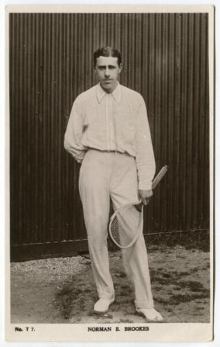 Norman E. Brookes. Rare original mono real photograph postcard of Brookes, standing full length, wearing tennis attire and holding a racket to his side circa 1907. Players name printed to lower border. Card no. T7 in a series issued by Edwin Trim & Co. of