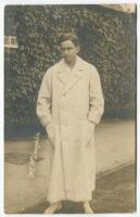 Maurice Evans McLoughlin. Rare original sepia real photograph postcard of McLoughlin, standing full length, wearing tennis attire and a ‘Owe-Forty’ or blanket coat (worn to and from the court) in front of the ivy clad entrance to centre court circa 1913. 