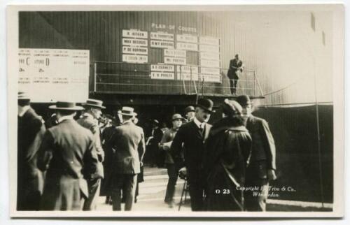 ‘Wimbledon 1914’. Rare original mono real photograph postcard showing the Plan of Courts and matches on the stand sides, with spectators to the foreground. Card no. 023 in a series issued by Edwin Trim & Co. of Wimbledon, with publishers name printed to r