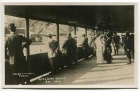 ‘Wimbledon 1914’. Rare original mono real photograph postcard showing spectators standing in a walkway/stand overlooking an outside court. Title to card ‘Wimbledon Tennis 1914’. Card no. 075 in a series issued by Edwin Trim & Co. of Wimbledon, with publi