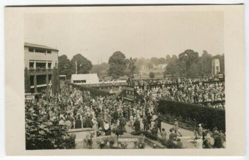 ‘Wimbledon Promenade’ circa 1929. Original mono real photograph postcard showing showing a general overhead view of the courts at Wimbledon, with promenade, plan of matches on fencing divide and crowds of spectators with Edwin Trim’s postcard kiosk to the