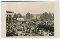 ‘Wimbledon Promenade’ circa 1929. Original mono real photograph postcard showing showing a general overhead view of the courts at Wimbledon, with promenade, plan of matches on fencing divide and crowds of spectators with Edwin Trim’s postcard kiosk to the