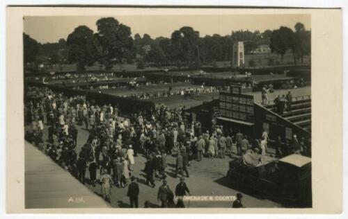 ‘Wimbledon. Promenade & Courts’. circa early 1920’s. Original mono real photograph postcard showing showing a general overhead view of the courts at Wimbledon, with walkways, plan of matches on fencing divide and crowds of spectators. Card no. A131 in a s