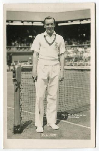 Frederick John Perry. Original mono real photograph postcard of Perry, standing full length, wearing tennis attire at the net at Wimbledon and holding a racket to his side. Players name printed to lower border. Card no. V57 in a series issued by Edwin Tri