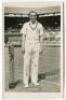 Frederick John Perry. Original mono real photograph postcard of Perry, standing full length, wearing tennis attire at the net at Wimbledon and holding a racket to his side. Players name printed to lower border. Card no. V57 in a series issued by Edwin Tri