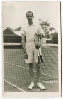 Eric John Filby. Original mono real photograph postcard of Filby, standing full length, wearing tennis attire at the net and holding two rackets to his side. Players name printed to lower border. Card no. V44 in a series issued by Edwin Trim & Co. of Wimb