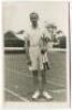 Eric John Filby. Original mono real photograph postcard of Filby, standing full length, wearing tennis attire at the net and holding two rackets to his side. Players name printed to lower border. Card no. V44 in a series issued by Edwin Trim & Co. of Wimb