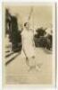 ‘The Champion. Villa Montalvo. Saratoga, Calif[ornia]. March 24th 1929’. Very rare privately printed original mono real photograph postcard of Helen Wills, eight times Wimbledon Champion, full length in tennis attire holding a tennis racket