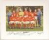 ‘England 1966 World Cup Winners’. Large colour copy photograph of the victorious England team seated and standing in rows with the manager, Alf Ramsey. The Captain, Bobby Moore, holding the trophy. Signed to the lower border by eight members of the team, 