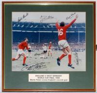 England World Cup Winners 1966. Colour photograph of Martin Peters, wearing the red number 16 shirt, celebrating scoring England’s second goal of the 1966 World Cup Final against West Germany. Boldly signed in black ink to the photograph by eight members 