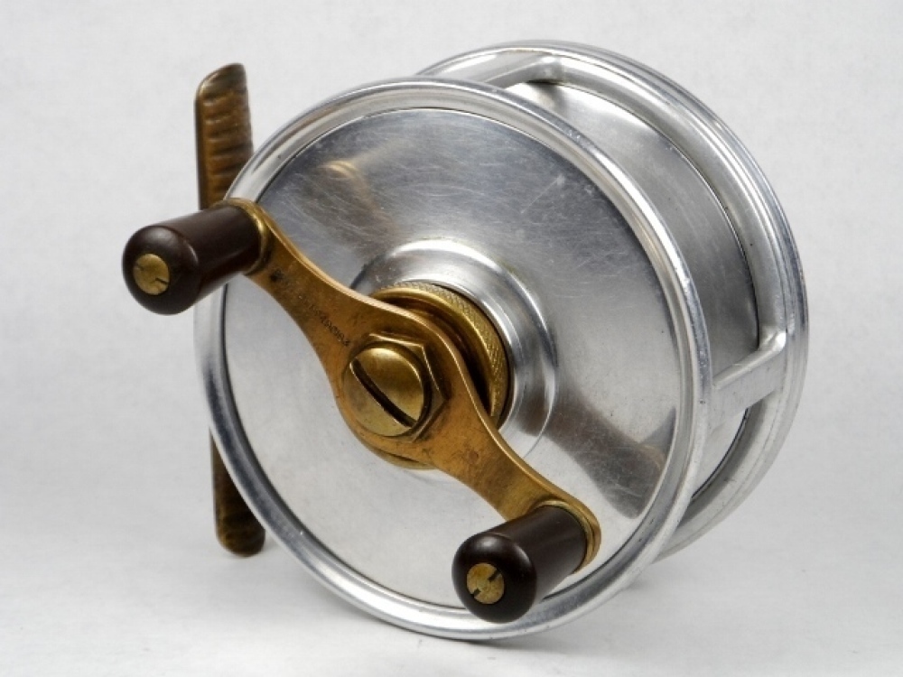 A rare Hardy Fortuna 4 ¼ big game fly/centre pin reel, twin reverse tapered  ebonite handles on shaped brass cross-bar winding arm mounte3d above a  milled tension wheel, ribbed brass foot, Andreas