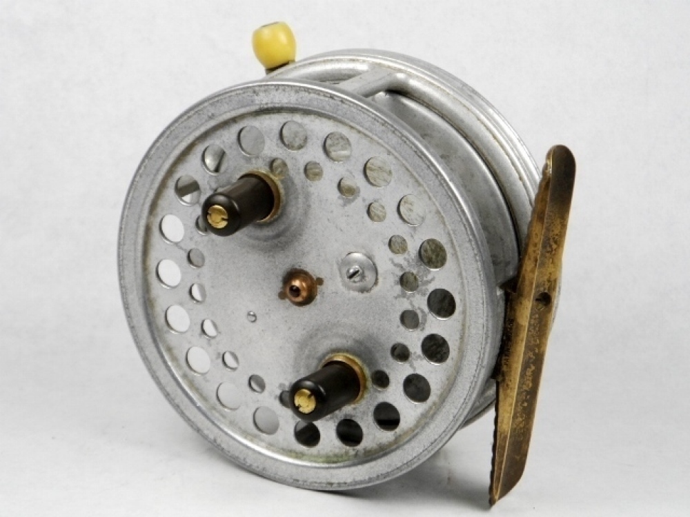 A scarce Hardy Super Silex 4 Duralumin alloy bait casting reel, shallow  cored drum with twin ebonite handles, jewelled spindle bearing and spring  release latch, ribbed brass foot, rim mounted ivorine casting