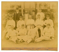 The Australians 1890. Original sepia photograph of the Australian team who played Lord Sheffield’s Eleven at Sheffield Park, East Sussex on the 8th-10th May 1890, standing and seated in rows wearing caps and cricket attire. The photograph laid down to car