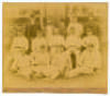 The Australians 1890. Original sepia photograph of the Australian team who played Lord Sheffield&rsquo;s Eleven at Sheffield Park, East Sussex on the 8th-10th May 1890, standing and seated in rows wearing caps and cricket attire. The photograph laid down to car