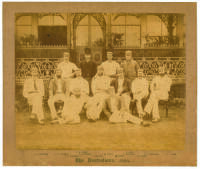 ‘The Australians 1884’. Original sepia photograph of the Australian team who played Lord Sheffield’s Eleven at Sheffield Park, East Sussex on the 12-14th May 1884, standing and seated in rows wearing blazers, caps and cricket attire. The photograph laid d