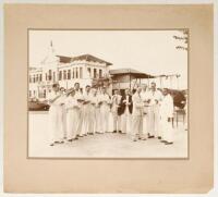 Sir Julien Cahn’s tour to Ceylon & Malaya. ‘Enjoying a Cup of Ceylon Tea. March 1936’. Original mono photograph of Sir Julien Cahn’s team being served tea. The team standing in one row in cricket attire. Typed label to verso reads, ‘Sir Julien Cahn’s Cric