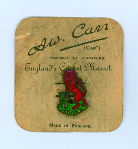 Australian tour of England 1926. ‘England’s Cricket Mascot’. Original lapel badge depicting a lion batsman, in red enamel, holding a cricket bat and standing in front of the wicket with ‘1926’ in a scroll below. The field in green enamel. The badge is com