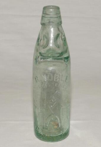 Cricket bottle. Attractive early cricket glass lemonade bottle, with ‘Codd’s patent’ glass ‘marble’ ball stop, with ‘B. Noble of Birstall‚‘ with figure of a batsman, stumps and ball to side and to the other ‘Kilner Bros, Thornhill, Leeds’ to the other sid