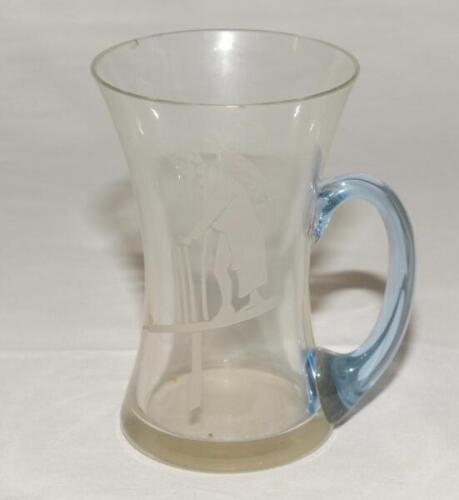 Evelyn Maitland ‘Lyn’ Wellings. Oxford University & Surrey 1928-1946. Concave glass mug (with handle) with image of ‘Old Father Time’ to one side and the intials ‘E.M.W.’ to the other. circa 1950’s (?). 5” tall. Very minor chip to rim otherwise in good co