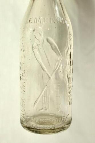 Victor Trumper. Attractive early cricket glass lemonade bottle, with image of Trumper in batting pose to centre with ‘Lemonade’ printed above and the maker’s name ‘Alex Mather & Sons, Singleton’ to sides. Circa early 1900’s.Approx 9” tall. Good/very good 