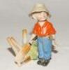 ‘Out First Ball‚‘. Kinsella 5.5” caricature spill vase of a young boy in batting stance in front of the broken wickets. Printed title below wickets and bat. ‘Copyright’ stamp to base. German circa early 1900’s. Two large chips to the boy’s hat otherwise i