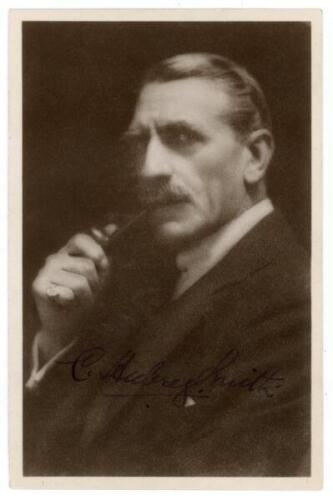 Sir Charles Aubrey Smith. Mono real photograph studio portrait postcard of Aubrey Smith dressed in formal suit smoking a pipe. Signed in black ink by Smith to the darker part of the photograph. Photo, Mannell. G/VG