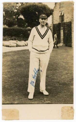 John Berry ‘Jack’ Hobbs. Surrey & England 1905-1934. Mono real photograph plainback postcard of Hobbs, full length, wearing Surrey sweater and England cap. Nicely signed in blue ink by Hobbs. Series unknown. Tape to corners, otherwise in good condition