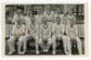 ‘Glamorganshire C.C.C. 1946’. Mono real photograph postcard of the 1946 Glamorgan team seated and standing in rows wearing cricket attire. Official stamp to verso for A. Wilkes & Son, West Bromwich with overlaid typed caption with players names. Players i