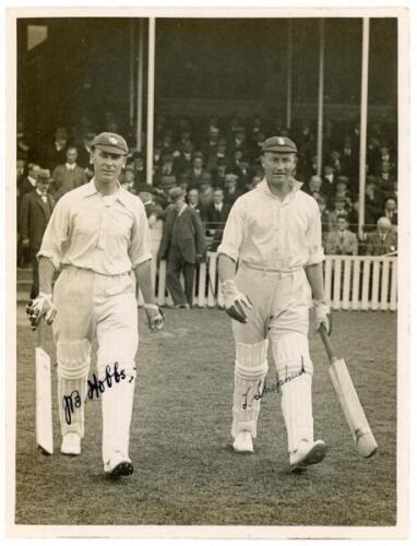 J.B. Hobbs and T.F. Shepherd c.1930. Excellent original mono press photograph of the two batsmen walking out to bat for Surrey at the Oval. Nicely signed in black ink by both Hobbs and Shepherd to photograph. Central News, London. 6.5”x8.5”. Small adhesiv