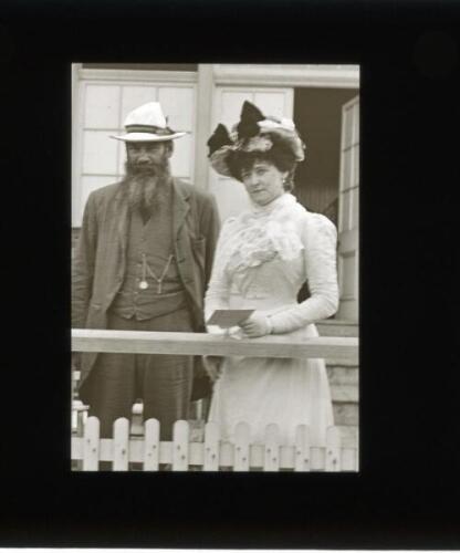 W.G. Grace 1900. Original glass plate/ magic lantern slide of an image of W.G. Grace standing on the steps of the Crystal Palace pavilion with an unknown lady. Grace is wearing a suit and straw hat, the lady dressed in fine Edwardian dress. The plate meas