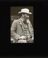 W.G. Grace 1900. Original glass plate/ magic lantern slide of an image of W.G. Grace in profle facing to his left, seated half length wearing a suit and hat, probably taken on the steps of the Crystal Palace cricket pavilion. The plate measures 3.25” squa