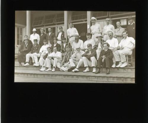 W.G. Grace 1900. Original glass plate/ magic lantern slide of an image of W.G. Grace seated and surrounded by players on the steps of the pavilion at Crystal Palace in 1900. The players appear to correspond with the match London County v Worcestershire, 1