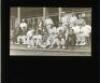 W.G. Grace 1900. Original glass plate/ magic lantern slide of an image of W.G. Grace seated and surrounded by players on the steps of the pavilion at Crystal Palace in 1900. The players appear to correspond with the match London County v Worcestershire, 1