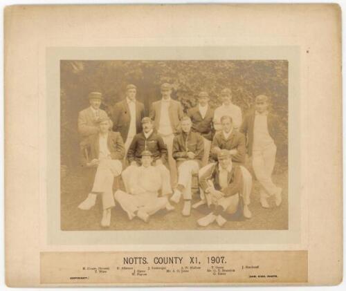 Nottinghamshire C.C.C. County Champions. ‘Notts. County XI, 1907’. Original sepia photograph of the Nottinghamshire team seated and standing in rows wearing cricket attires, caps and assorted blazers. Players featured are A.O. Jones (captain), E. Alletson