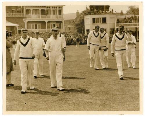 The Ashes. England v Australia 1938. Original sepia press photograph of Don Bradman leading the Australian team on to the field at the start of the first Test, Trent Bridge, 10th- 14th June 1938. Other players featured include McCabe, Barnett, Fleetwood-S