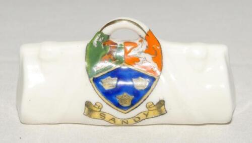 Cricket bag. Small crested china cricket bag with colour emblem for ‘Sandy’. Approx 3.25” long. Arcadian China. G