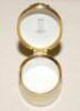 Cricket pillbox. Sir Leonard Hutton. Modern enamelled oval white and cream pillbox hand decorated with a portrait of Hutton full length in cricket attire walking out to bat . Stumps with bails decoration to inside lid. Produced by Crummles. VG - 2