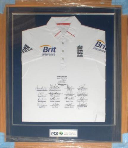 England tour to India 2012/13. England short sleeve white shirt with three lions and crown emblem to chest, and sponsor’s logos to chest and sleeves. The shirt fully signed to the front by the seventeen playing members of the England touring party with pr