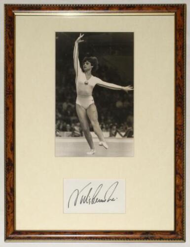 Gymnastics. Nadia Comaneci. Original mono photograph of Comaneci in action in the floor exercise at the World Gymnastics Championships, Strasbourg, 24th October 1978. The photograph measures approx. 6”x9.5”, mounted with signature of Comaneci window mount