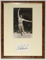 Gymnastics. Nadia Comaneci. Original mono photograph of Comaneci in action in the floor exercise at the World Gymnastics Championships, Strasbourg, 24th October 1978. The photograph measures approx. 6”x9.5”, mounted with signature of Comaneci window mount