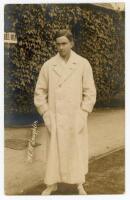 Maurice Evans McLoughlin. Rare original sepia real photograph postcard of McLoughlin, standing full length, wearing tennis attire and a ‘Owe-Forty’ or blanket coat (worn to and from the court), in front of the ivy clad entrance to centre court circa 1913.