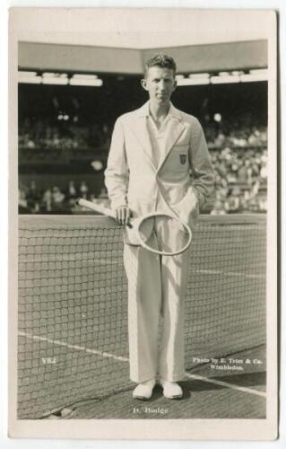 John Donald Budge. Original mono real photograph postcard of Budge, standing full length, wearing tennis attire and blazer at the net at Wimbledon and holding a racket. Players name printed to lower border. Card no. V82 in a series issued by Edwin Trim & 