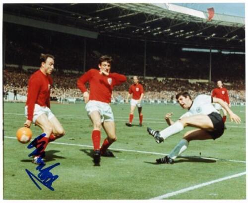 World Cup Final 1966. England v West Germany. Two copy press photographs of match action, one a colour photograph signed by George Cohen, the other black and white signed by Martin Peters. Both 10”x8”. VG