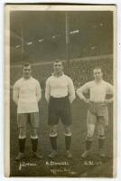 Arthur Grimsdell. Tottenham Hotspur 1912-1929, James Cantrell. Tottenham Hotspur 1912-1922 and Herbert Bliss. Tottenham Hotspur 1912-1922. Mono real photograph postcard of the three players, full length, in Spurs attire on the pitch in front of a packed W